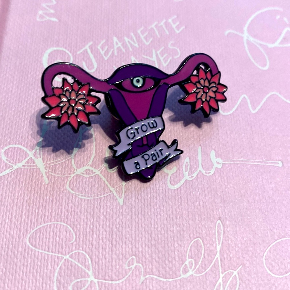 Grow a pair of ovaries enamel pin